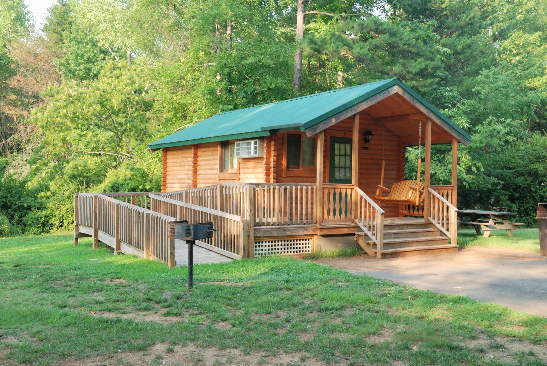 Cabin in the middle of the woods on sunny day with a handicap ramp